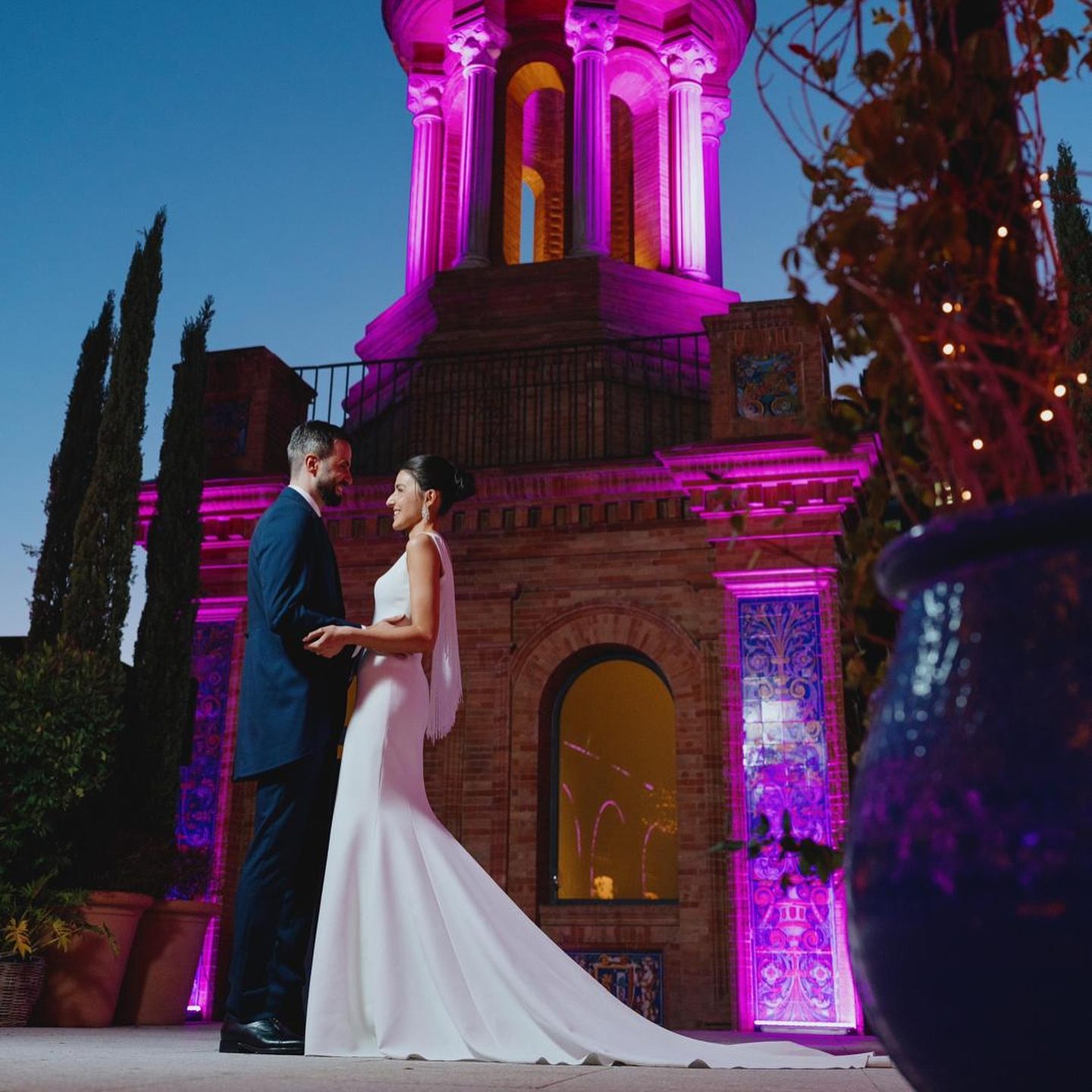Pareja de novios junto al templete iluminado, de noche
